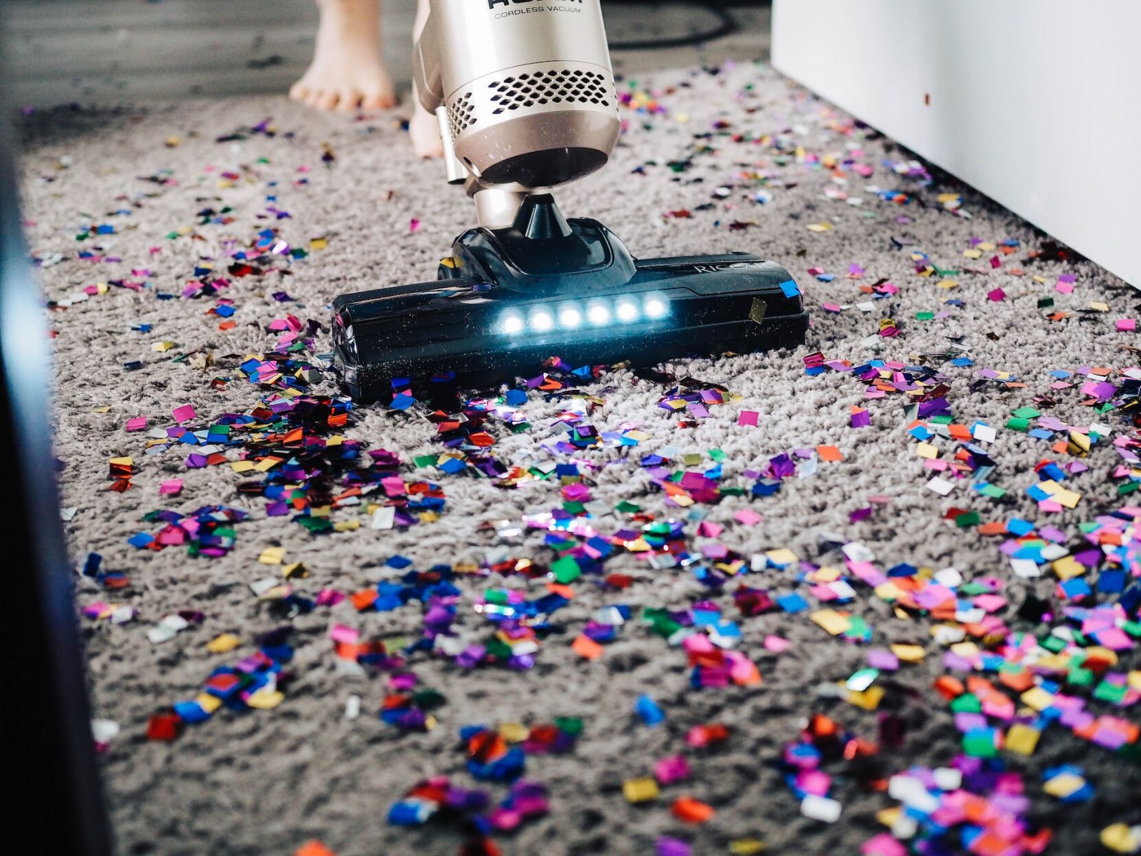 Vacuum sucks up debris on floor, supporting indoor air quality